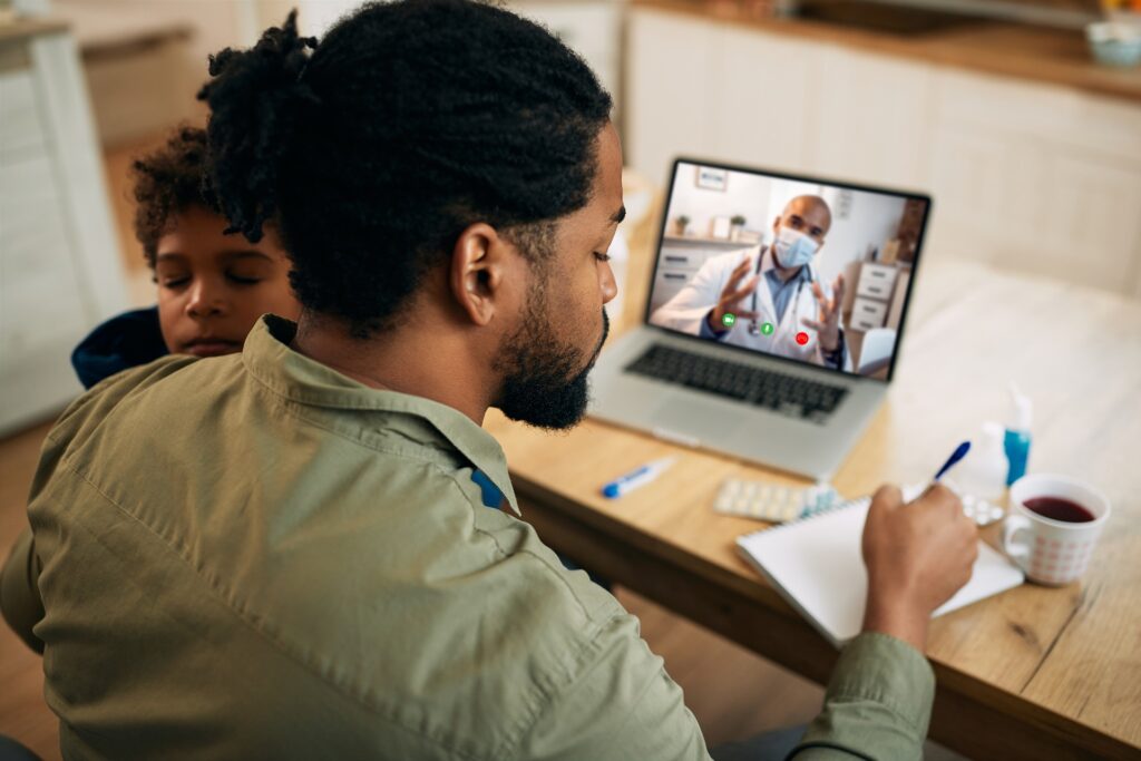 Person in a video call with a doctor | hospital negligence lawyers​ | Menzer Law|Girl in a green sweater sitting on a couch holding a tablet | personal injury law firm​ | Menzer Law|Two adults and a child sitting with a laptop | medical malpractice law firm​ | Menzer Law