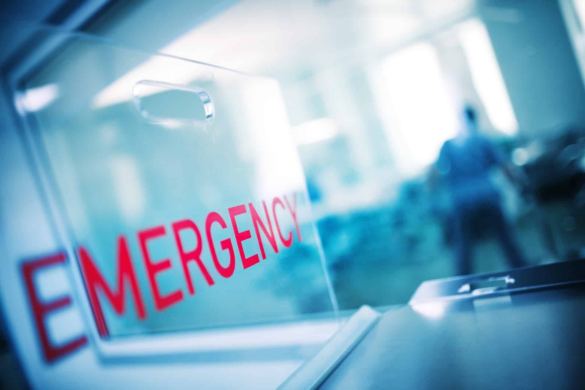 Blurred hospital scene through a glass door | medical malpractice lawyer​ | Menzer Law|A physician is giving pills to a patient | medical malpractice law firm​ | Menzer Law|A team of healthcare workers in scrubs and masks | medical malpractice lawyer​​ | Menzer Law