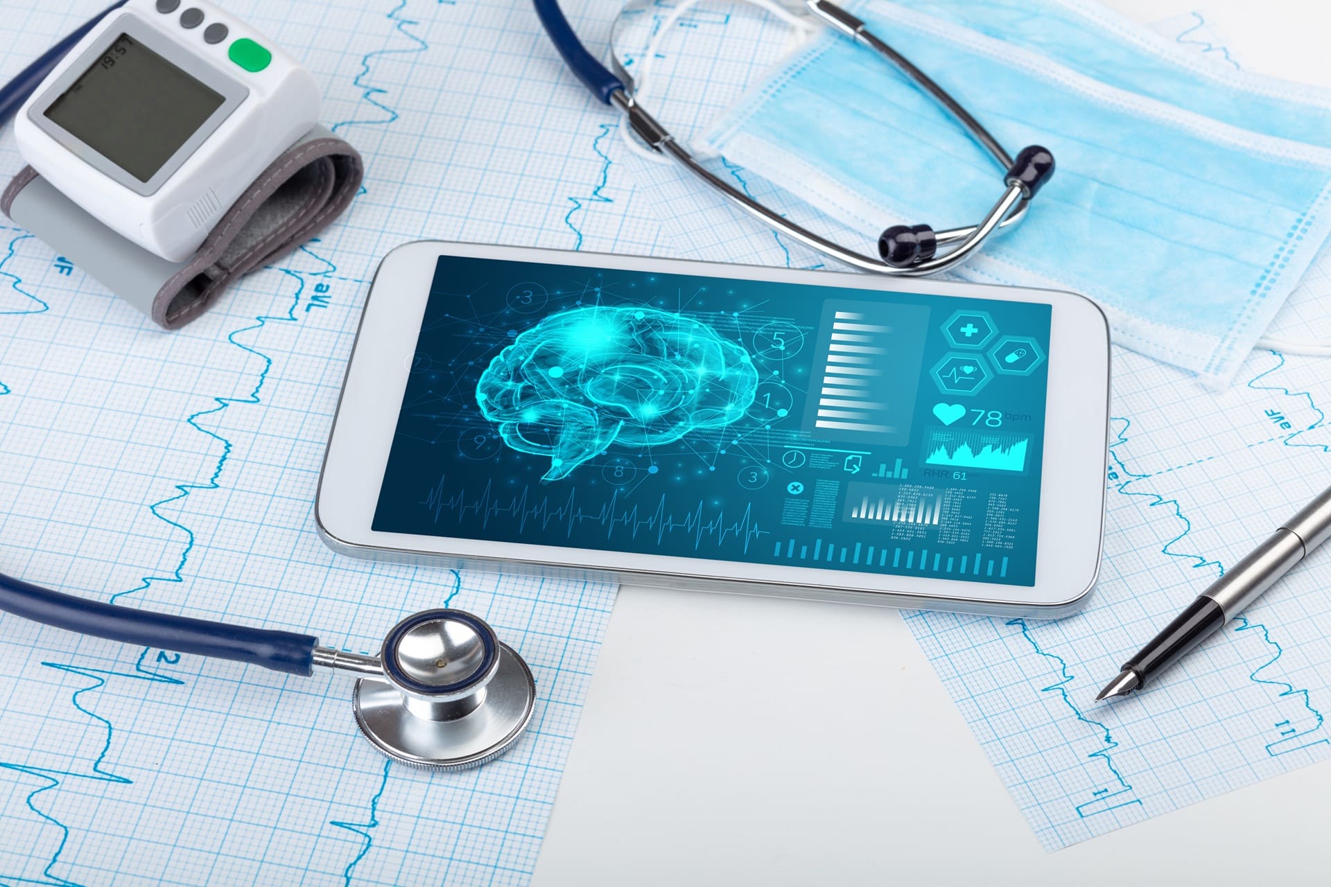 A series of medical devices sit on medical graph papers.